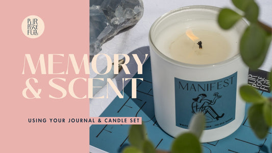 prompted journal lays open with pen ready to write. palo santo candle with notes of sage and sandalwood scents. 